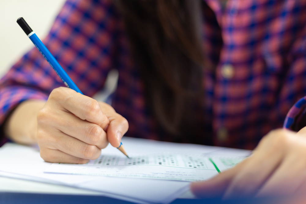 student holding a pencil