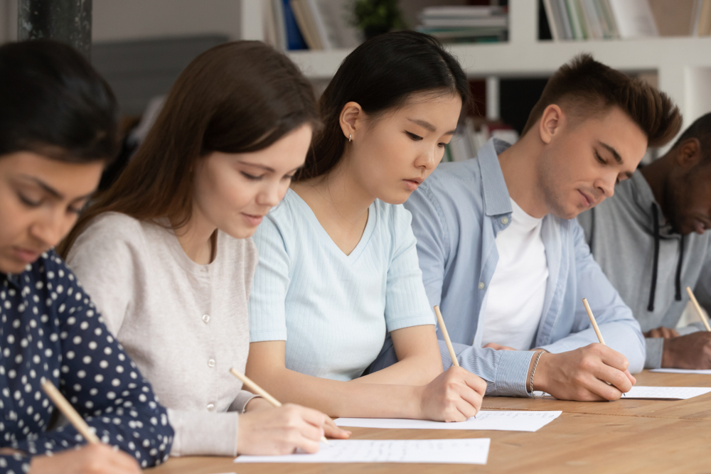 group of focused students writing